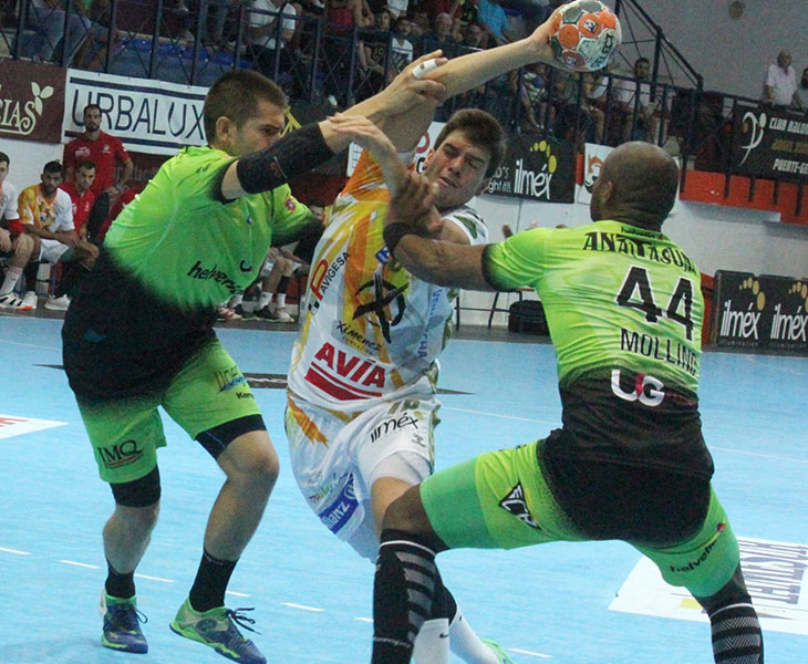 David Estepa intenta penetrar entre dos jugadores del Helvetia Anaitasuna