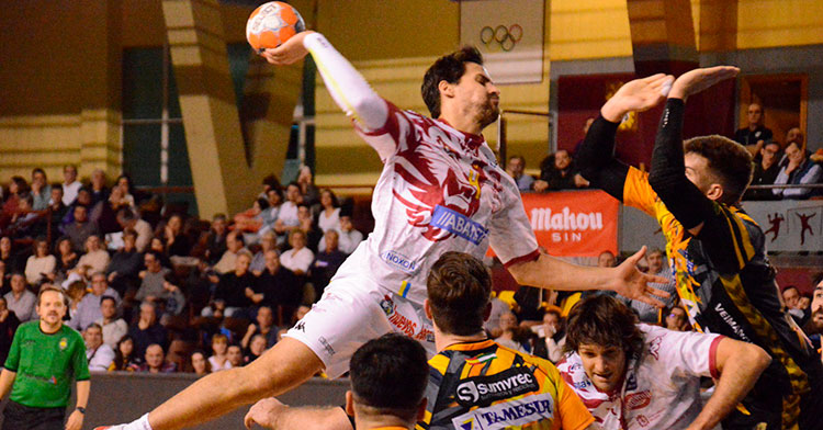 Un jugador del Abanca Ademar de León se levanta sobre la defensa pontana para encara el intento de bloqueo de Ruslan Dashko