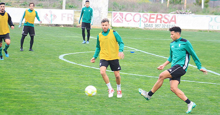 Felipe Veloso pasa el balón ante la llegada de Vera con Raúl Cámara y otros jugadores del primer equipo al fondo.