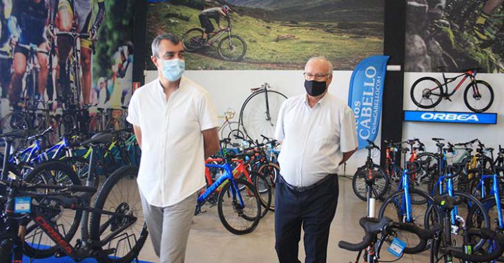 Antonio Cabello junto al director general de la Vuelta a España rodeado de bicicletas.