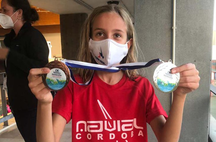 La joven Candela González muestra sus dos preseas que sumaron para el medallero de Navial.
