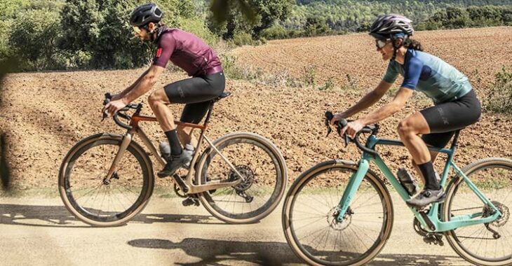 Una pareja paseando con sus bicicletas de gravel.