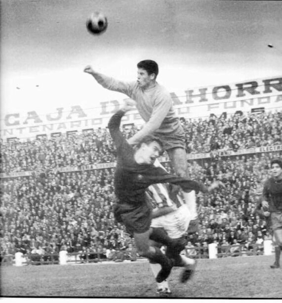Miguel Reina despejando de puños ante el delantero del Barça Zaldúa en El Arcángel 