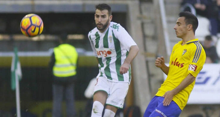 Antoñito despejando un balón ante un jugador del Cádiz en El Arcángel en aquella temporada 2026-17.
