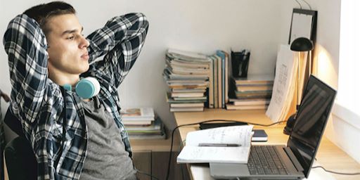 Un chico dándose un respiro mientras estudia davante.