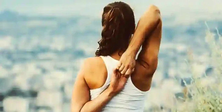 Una mujer estirarndo.