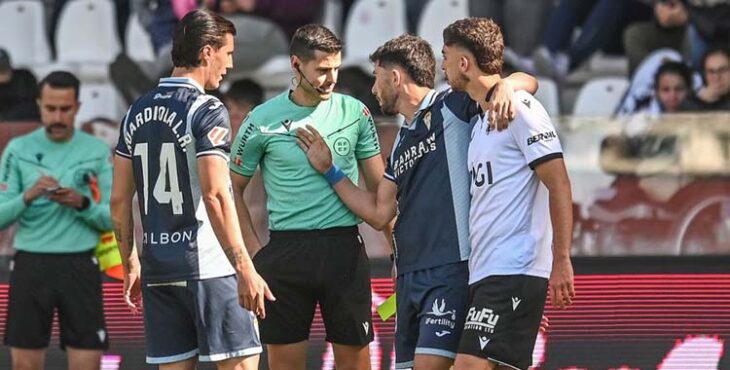Sergi Guardiola escuchando a Jacobo dirigirse al colegiado abrazado a un jugador del Burgos.